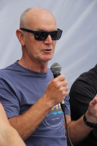 Richard Attree in 2019, aged 66, microphone in hand, speaking at the Adeje book fair, Tenerife.